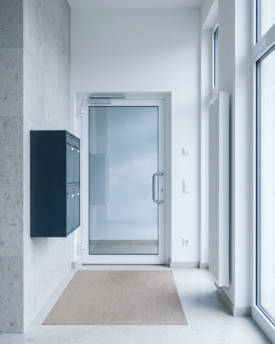 Sauberer Hauseingang mit Glastür und Briefkastenanlage